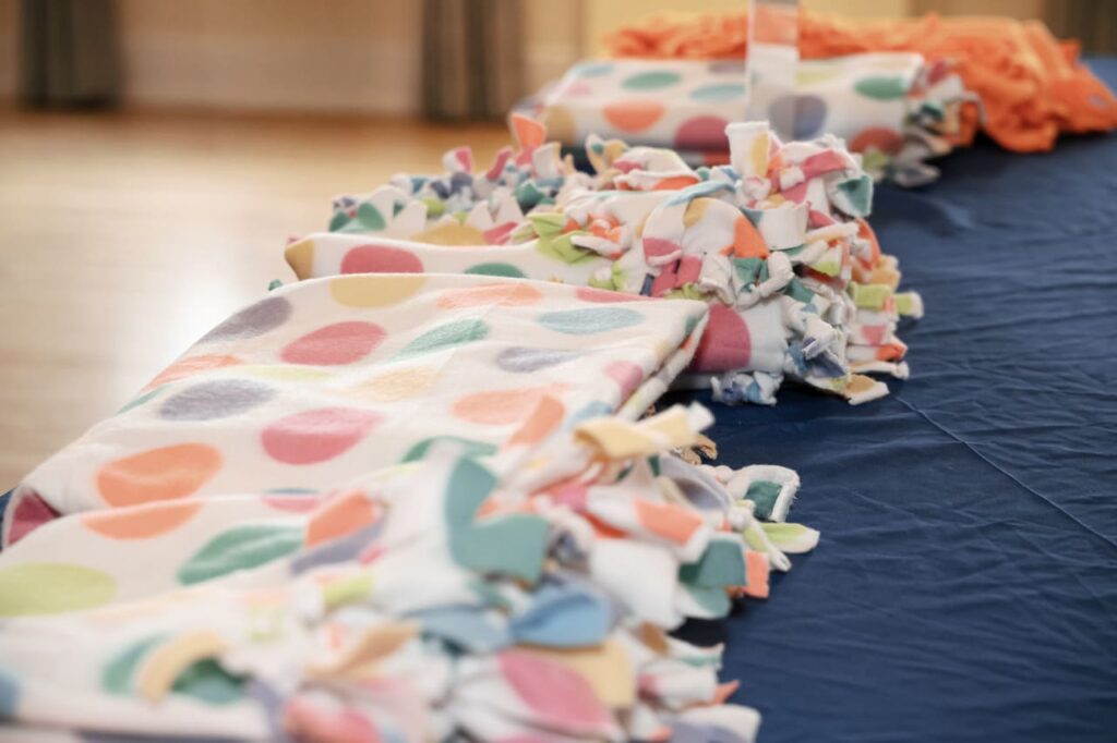 GFWC Operation Smile Miami, The Miami Woman's Club Day of Service, Operation Smile Blanket Drive, No-Sew Fleece Blankets GFWC, Smile Bags creation, Operation Smile Patients Support, Armando Paz Guest Speaker, The Paz Foundation Sponsorship, Community Service Miami.
